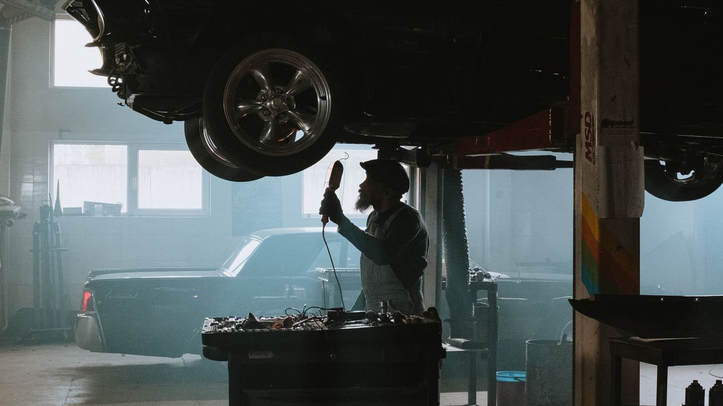 Car raised on a lift in a dark garage